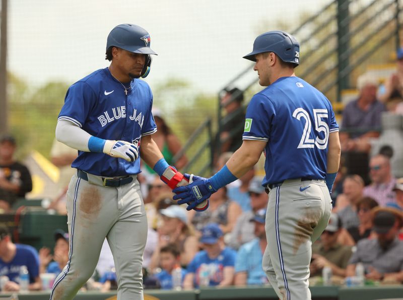 Mar 5, 2024; Bradenton, Florida, USA;  Toronto Blue Jays second baseman Santiago Espinal (5) is congratulated by  left fielder Daulton Varsho (25) after he scored a run during the fifth inning against the Pittsburgh Pirates at LECOM Park. Mandatory Credit: Kim Klement Neitzel-USA TODAY Sports