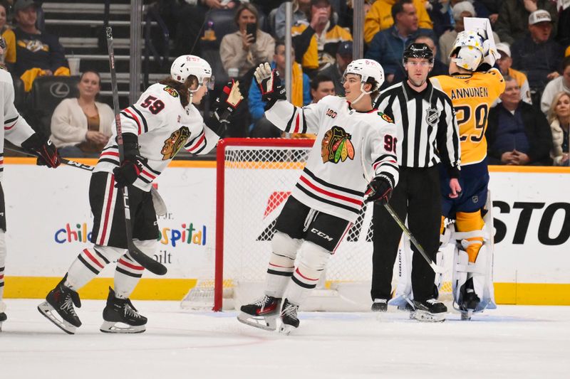 Feb 26, 2026; Nashville, Tennessee, USA;  Chicago Blackhawks left wing Tyler Bertuzzi (59) celebrates scoring with center Frank Nazar (91) against the Nashville Predators during the third period at Bridgestone Arena. Mandatory Credit: Steve Roberts-Imagn Images