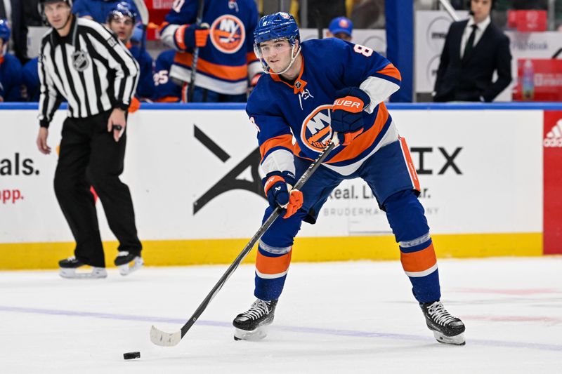 Dec 29, 2023; Elmont, New York, USA; New York Islanders defenseman Noah Dobson (8) looks to pass against the Washington Capitals during the second period at UBS Arena. Mandatory Credit: Dennis Schneidler-USA TODAY Sports