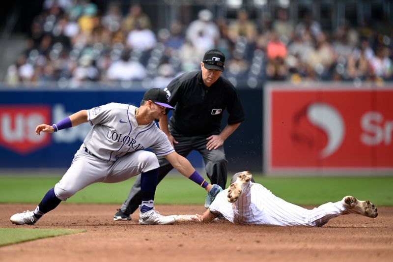 Sep 20, 2023; San Diego, California, USA; San Diego Padres second baseman Matthew Batten (right) is tagged out by Colorado Rockies shortstop Ezequiel Tovar (left) attempting to steal second base during the second inning at Petco Park. Mandatory Credit: Orlando Ramirez-USA TODAY Sports