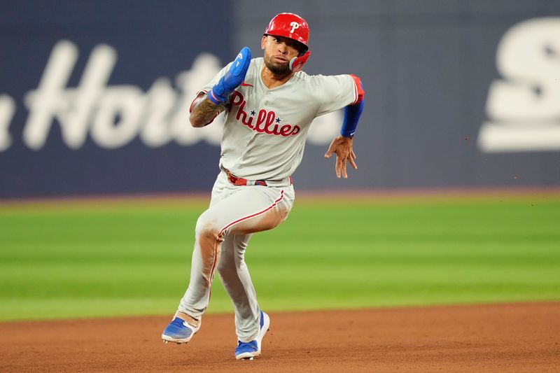 Aug 15, 2023; Toronto, Ontario, CAN; Philadelphia Phillies third baseman Edmundo Sosa (33) heads for home to score on a double hit by center fielder Johan Rojas (not pictured) during the sixth inning at Rogers Centre. Mandatory Credit: John E. Sokolowski-USA TODAY Sports