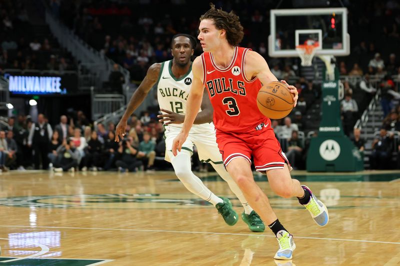 MILWAUKEE, WISCONSIN - OCTOBER 14: Josh Giddey #3 of the Chicago Bulls drives around Taurean Prince #12 of the Milwaukee Bucks during the first half of a preseason game at Fiserv Forum on October 14, 2024 in Milwaukee, Wisconsin. NOTE TO USER: User expressly acknowledges and agrees that, by downloading and or using this photograph, User is consenting to the terms and conditions of the Getty Images License Agreement. (Photo by Stacy Revere/Getty Images)