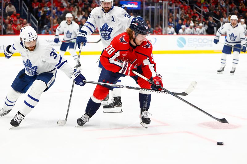 Mar 20, 2024; Washington, District of Columbia, USA; Washington Capitals defenseman Rasmus Sandin (38) battles for the puck between Toronto Maple Leafs defenseman Timothy Liljegren (37) and Maple Leafs center Auston Matthews (34) during the third period at Capital One Arena. Mandatory Credit: Amber Searls-USA TODAY Sports