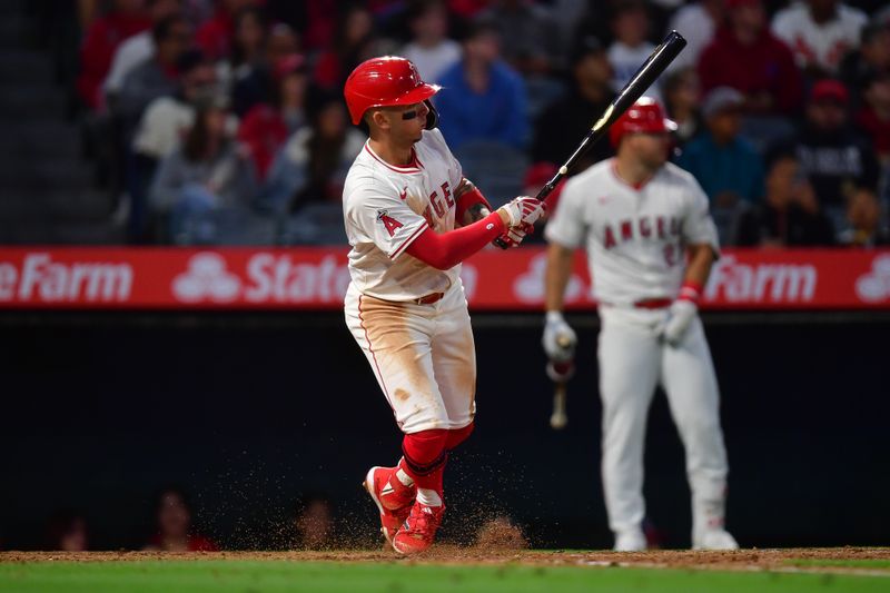 Apr 23, 2024; Anaheim, California, USA; Los Angeles Angels shortstop Zach Neto (9) hits an RBI double against the Baltimore Orioles during the fourth inning at Angel Stadium. Mandatory Credit: Gary A. Vasquez-USA TODAY Sports