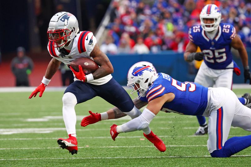 New England Patriots wide receiver DeMario Douglas, left, gets past Buffalo Bills defensive end AJ Epenesa during the second half of an NFL football game in Orchard Park, N.Y., Sunday, Dec. 31, 2023. (AP Photo/Jeffrey T. Barnes )