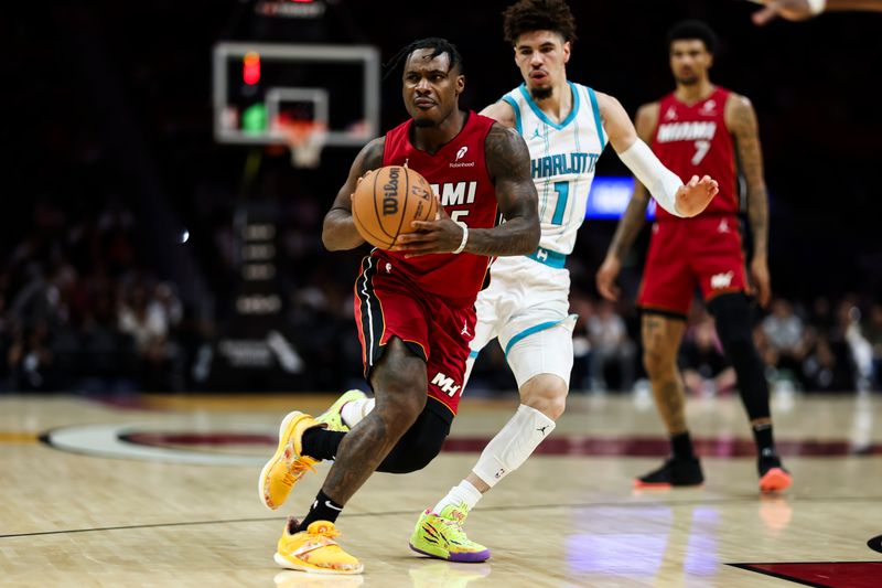 MIAMI, FLORIDA - MARCH 10: Davion Mitchell #45 of the Miami Heat looks to pass during the first quarter against the Charlotte Hornets at Kaseya Center on March 10, 2025 in Miami, Florida. NOTE TO USER: User expressly acknowledges and agrees that, by downloading and or using this photograph, User is consenting to the terms and conditions of the Getty Images License Agreement. (Photo by Brennan Asplen/Getty Images)