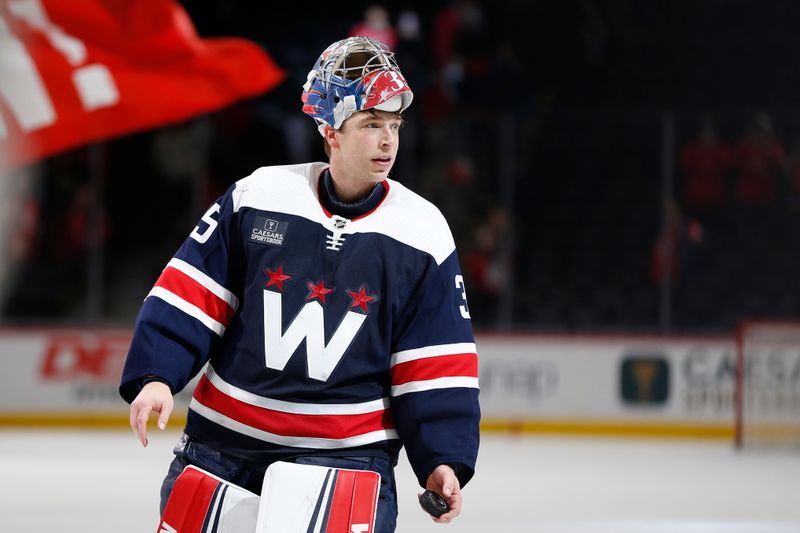 Jan 7, 2024; Washington, District of Columbia, USA; Washington Capitals goaltender Darcy Kuemper (35) throws a puck into the stands after winning the third star of the game against the Los Angeles Kings at Capital One Arena. Mandatory Credit: Amber Searls-USA TODAY Sports