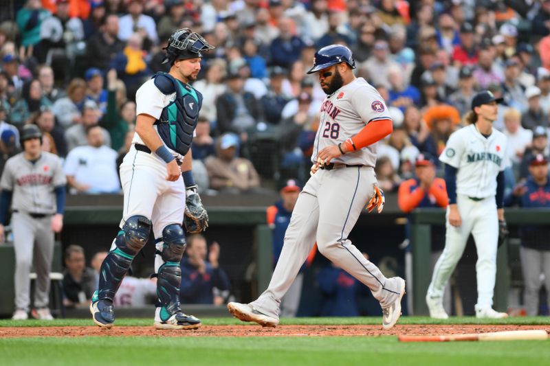 May 27, 2024; Seattle, Washington, USA; Houston Astros designated hitter Jon Singleton (28) scores a run against the Seattle Mariners during the fifth inning at T-Mobile Park. Mandatory Credit: Steven Bisig-USA TODAY Sports