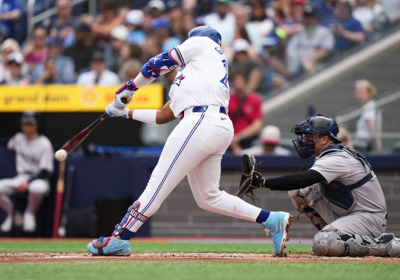 Jun 30, 2024; Toronto, Ontario, CAN; Toronto Blue Jays first base Vladimir Guerrero Jr. (27) hits a single against the New York Yankees during the first inning at Rogers Centre. Mandatory Credit: Nick Turchiaro-USA TODAY Sports