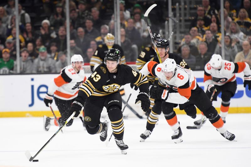 Mar 16, 2024; Boston, Massachusetts, USA; Boston Bruins left wing Danton Heinen (43) skates with the puck while Philadelphia Flyers defenseman Travis Sanheim (6) gives chase during the third period at TD Garden. Mandatory Credit: Bob DeChiara-USA TODAY Sports