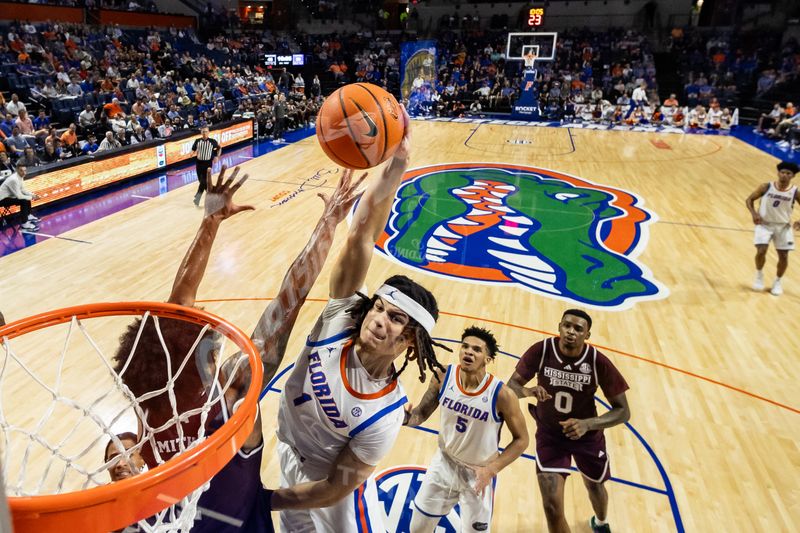 Jan 24, 2024; Gainesville, Florida, USA; Florida Gators guard Walter Clayton Jr. (1) dunks the ball over Mississippi State Bulldogs forward Tolu Smith (1) during the second half at Exactech Arena at the Stephen C. O'Connell Center. Mandatory Credit: Matt Pendleton-USA TODAY Sports