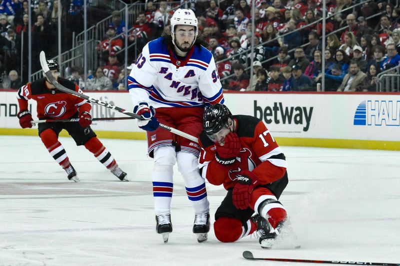 Feb 22, 2024; Newark, New Jersey, USA; New Jersey Devils defenseman Simon Nemec (17) reacts after an injury as New York Rangers center Mika Zibanejad (93) looks on during the second period against the New York Rangers at Prudential Center. Mandatory Credit: John Jones-USA TODAY Sports