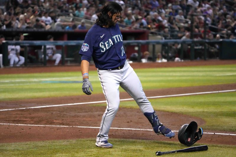 Jul 30, 2023; Phoenix, Arizona, USA; Seattle Mariners third baseman Eugenio Suarez (28) kicks his helmet after striking out against the Arizona Diamondbacks during the fourth inning at Chase Field. Mandatory Credit: Joe Camporeale-USA TODAY Sports