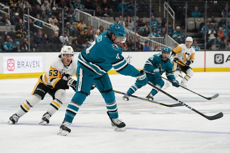 Jan 27, 2025; San Jose, California, USA;  San Jose Sharks defenseman Cody Ceci (4) passes against Pittsburgh Penguins center Philip Tomasino (53) in the first period at SAP Center at San Jose. Mandatory Credit: David Gonzales-Imagn Images