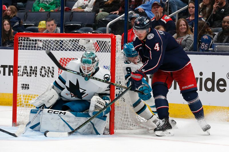 Mar 16, 2024; Columbus, Ohio, USA; San Jose Sharks goalie Magnus Chrona (30) makes a save on the wrap around shot of Columbus Blue Jackets Forward Cole Sillinger (4) during the third period at Nationwide Arena. Mandatory Credit: Russell LaBounty-USA TODAY Sports