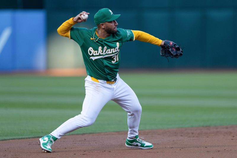 Aug 19, 2024; Oakland, California, USA; Oakland Athletics third baseman Abraham Toro (31) throws the ball during the third inning against the Tampa Bay Rays at Oakland-Alameda County Coliseum. Mandatory Credit: Stan Szeto-USA TODAY Sports