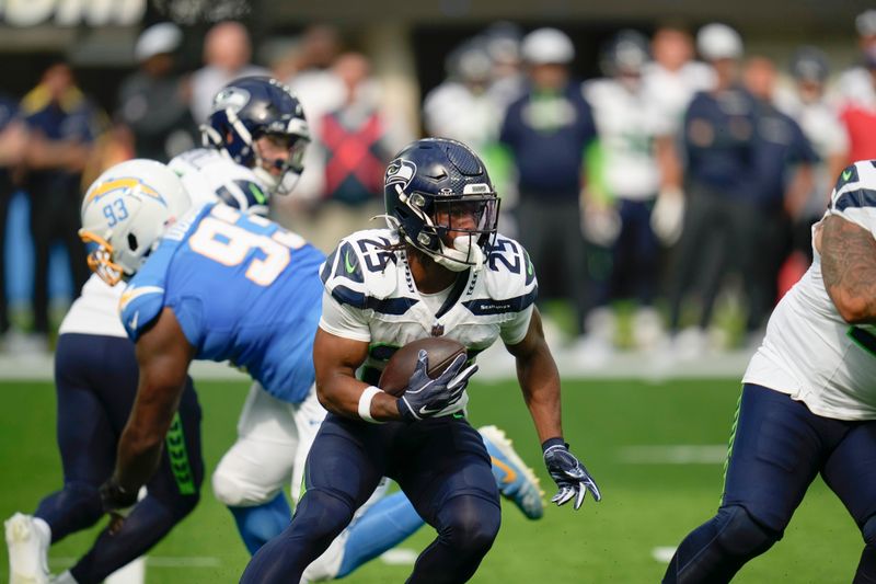 Seattle Seahawks running back Kenny McIntosh (25) runs against the Los Angeles Chargers during the first half of a preseason NFL football game in Inglewood, Calif., Saturday, Aug. 10, 2024. (AP Photo/Gregory Bull)