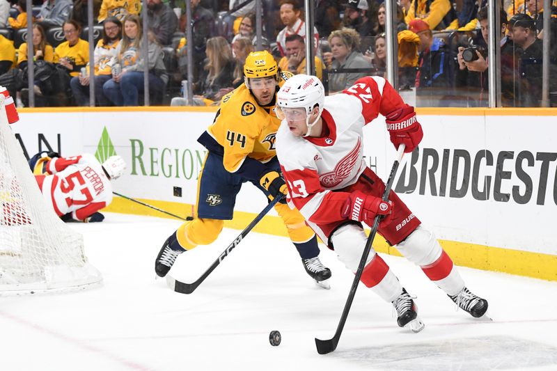 Mar 23, 2024; Nashville, Tennessee, USA; Detroit Red Wings left wing Lucas Raymond (23) handles the puck against Nashville Predators left wing Kiefer Sherwood (44) during the second period at Bridgestone Arena. Mandatory Credit: Christopher Hanewinckel-USA TODAY Sports