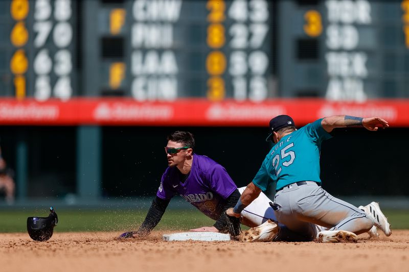 Apr 21, 2024; Denver, Colorado, USA; Colorado Rockies center fielder Brenton Doyle (9) safely steals second against Seattle Mariners second baseman Dylan Moore (25) in the sixth inning at Coors Field. Mandatory Credit: Isaiah J. Downing-USA TODAY Sports