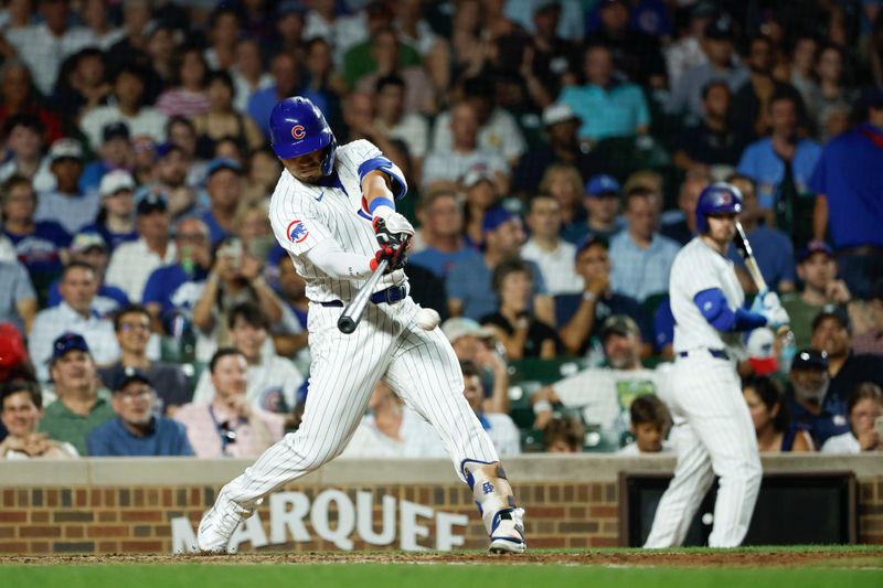 Jun 17, 2024; Chicago, Illinois, USA; Chicago Cubs outfielder Seiya Suzuki (27) singles against the San Francisco Giants during the sixth inning at Wrigley Field. Mandatory Credit: Kamil Krzaczynski-USA TODAY Sports