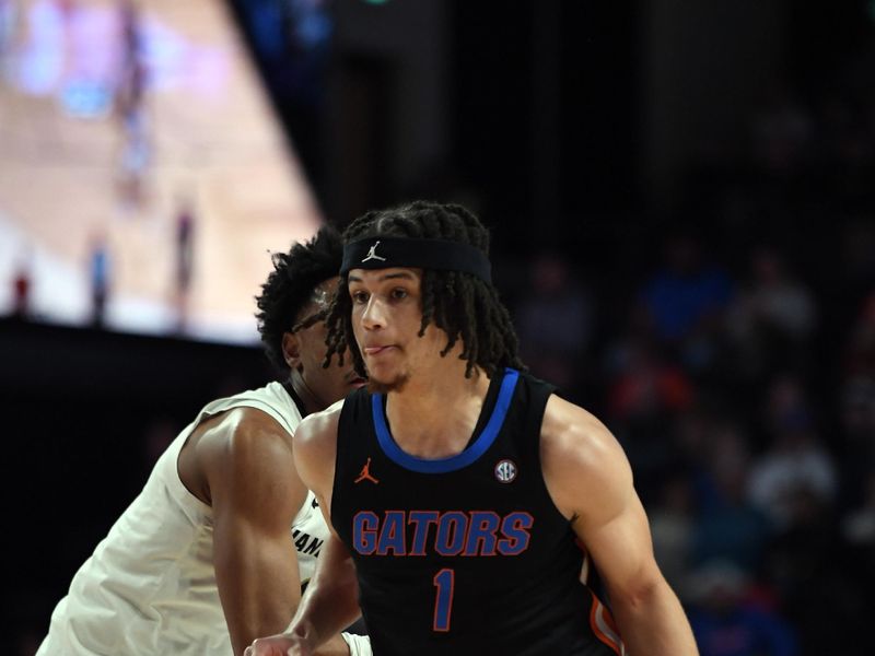 Mar 9, 2024; Nashville, Tennessee, USA; Florida Gators guard Walter Clayton Jr. (1) dribbles the ball past Vanderbilt Commodores guard Tyrin Lawrence (0) during the first half at Memorial Gymnasium. Mandatory Credit: Christopher Hanewinckel-USA TODAY Sports