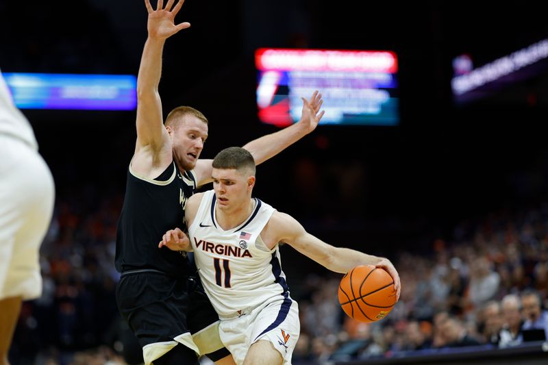 Feb 17, 2024; Charlottesville, Virginia, USA; Virginia Cavaliers guard Isaac McKneely (11) drives to the basket as Wake Forest Demon Deacons guard Cameron Hildreth (2) defends in the second half at John Paul Jones Arena. Mandatory Credit: Geoff Burke-USA TODAY Sports