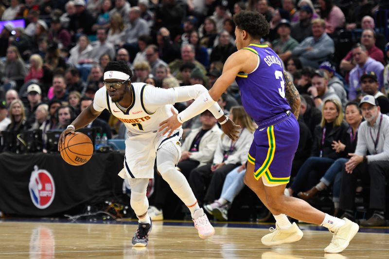 SALT LAKE CITY, UTAH - JANUARY 10: Reggie Jackson #7 of the Denver Nuggets drives against Keyonte George #3 of the Utah Jazz during the second half at Delta Center on January 10, 2024 in Salt Lake City, Utah.  NOTE TO USER: User expressly acknowledges and agrees that, by downloading and or using this photograph, User is consenting to the terms and conditions of the Getty Images License Agreement. (Photo by Alex Goodlett/Getty Images)