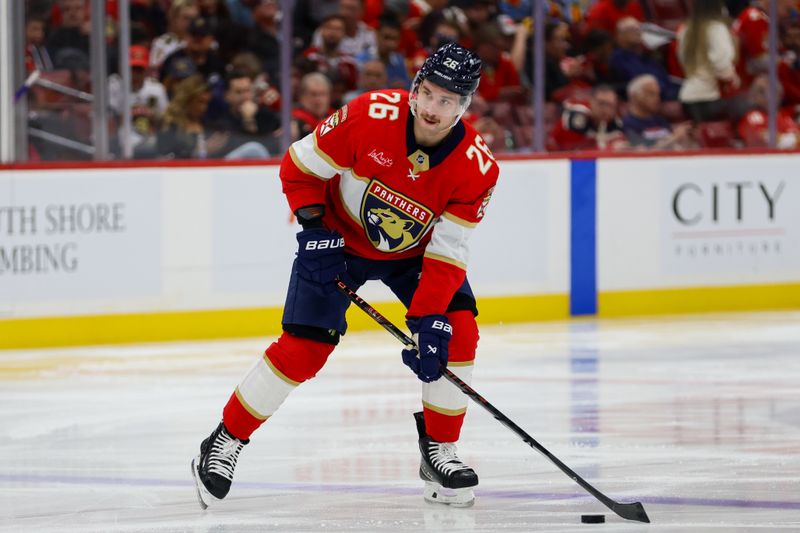 Nov 7, 2024; Sunrise, Florida, USA; Florida Panthers defenseman Uvis Balinskis (26) moves the puck against the Nashville Predators during the second period at Amerant Bank Arena. Mandatory Credit: Sam Navarro-Imagn Images