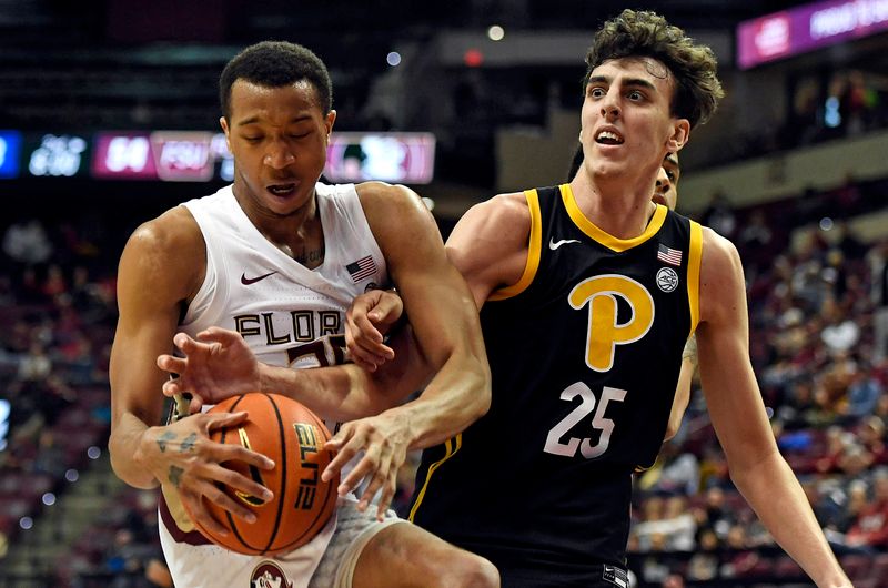 Feb 11, 2023; Tallahassee, Florida, USA; Pittsburgh Panthers forward Guillermo Diaz Graham (25) fights for a rebound against Florida State Seminoles guard Matthew Cleveland (35) during the second half at Donald L. Tucker Center. Mandatory Credit: Melina Myers-USA TODAY Sports