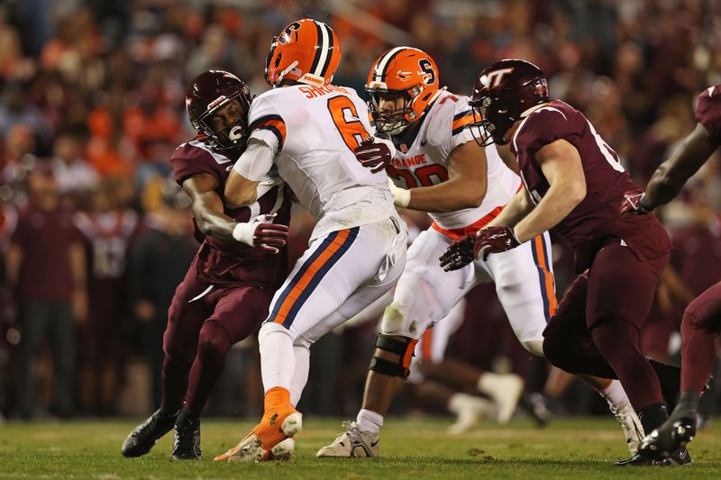 Oct 26, 2023; Blacksburg, Virginia, USA; Syracuse Orange quarterback Garrett Shrader (6) is sacked by Virginia Tech Hokies defensive lineman James Jennette (57) during the fourth quarter at Lane Stadium. Mandatory Credit: Peter Casey-USA TODAY Sports