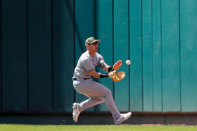 May 21, 2023; Cincinnati, Ohio, USA; New York Yankees right fielder Jake Bauers (61) attempts to field the ball hit by Cincinnati Reds first baseman Spencer Steer (not pictured) in the first inning at Great American Ball Park. Mandatory Credit: Katie Stratman-USA TODAY Sports