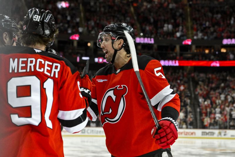 Oct 19, 2024; Newark, New Jersey, USA; New Jersey Devils defenseman Brenden Dillon (5) reacts after a goal by New Jersey Devils center Nico Hischier (not pictured) during the second period against the Washington Capitals at Prudential Center. Mandatory Credit: John Jones-Imagn Images