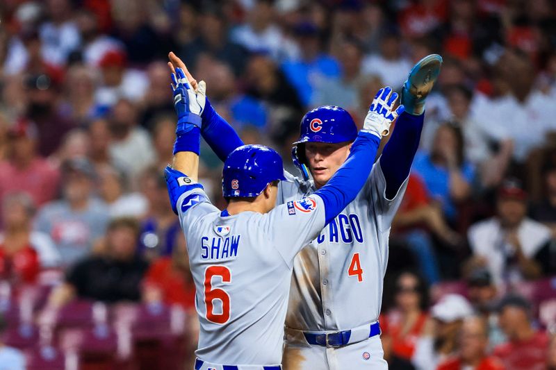 Sep 19, 2025; Cincinnati, Ohio, USA; Chicago Cubs third baseman Matt Shaw (6) high fives outfielder Pete Crow-Armstrong (4) after hitting a two-run home run in the fourth inning against the Cincinnati Reds at Great American Ball Park. Mandatory Credit: Katie Stratman-Imagn Images