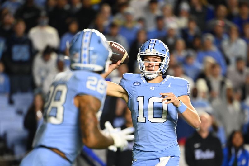 Nov 11, 2023; Chapel Hill, North Carolina, USA; North Carolina Tar Heels quarterback Drake Maye (10) looks to pass to running back Omarion Hampton (28) in the first quarter at Kenan Memorial Stadium. Mandatory Credit: Bob Donnan-USA TODAY Sports