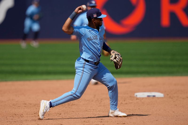 Jul 21, 2024; Toronto, Ontario, CAN; Toronto Blue Jays shortstop Leo Jimenez (49) goes to throw out Detroit Tigers short stop Javier Baez (not pictured) during the ninth inning at Rogers Centre. Mandatory Credit: John E. Sokolowski-USA TODAY Sports