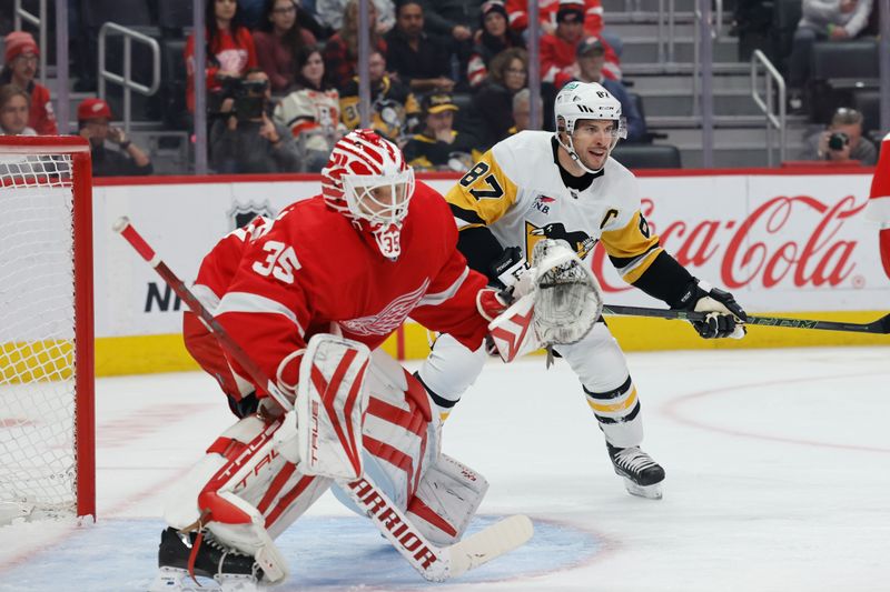 Oct 18, 2023; Detroit, Michigan, USA; Pittsburgh Penguins center Sidney Crosby (87) looks for the pass in front of Detroit Red Wings goaltender Ville Husso (35) in the first period at Little Caesars Arena. Mandatory Credit: Rick Osentoski-USA TODAY Sports