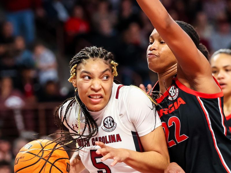 Feb 26, 2023; Columbia, South Carolina, USA; South Carolina Gamecocks forward Victaria Saxton (5) attempts to drive around Georgia Lady Bulldogs forward Malury Bates (22) in the first half at Colonial Life Arena. Mandatory Credit: Jeff Blake-USA TODAY Sports