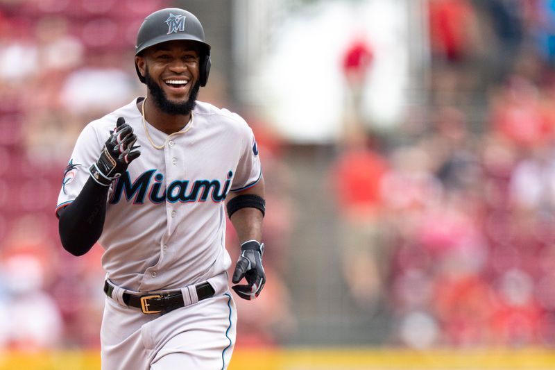 Aug 9, 2023; Cincinnati, OH, USA; Miami Marlins left fielder Bryan De La Cruz (14) smiles as he rounds the bases after hitting a go ahead solo home run in the ninth inning of the MLB baseball game between Cincinnati Reds and Miami Marlins at Great American Ball Park in Cincinnati on Wednesday, Aug. 9, 2023.  Mandatory Credit: Albert Cesare-USA TODAY Sports