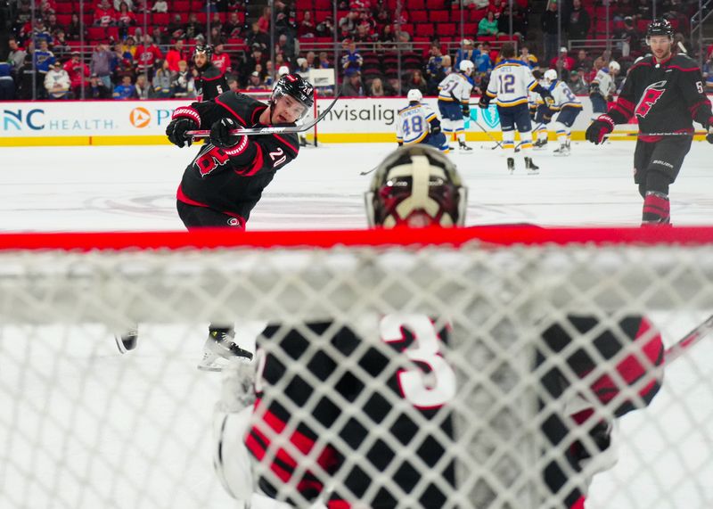 Jan 6, 2024; Raleigh, North Carolina, USA; Carolina Hurricanes center Sebastian Aho (20) takes a shot during the warmups before the game against the St. Louis Blues at PNC Arena. Mandatory Credit: James Guillory-USA TODAY Sports