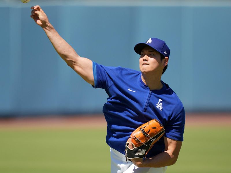 Jun 15, 2024; Los Angeles, California, USA; Los Angeles Dodgers player Shohei Ohtani throws before the game against the Kansas City Royals at Dodger Stadium. Mandatory Credit: Kirby Lee-USA TODAY Sports