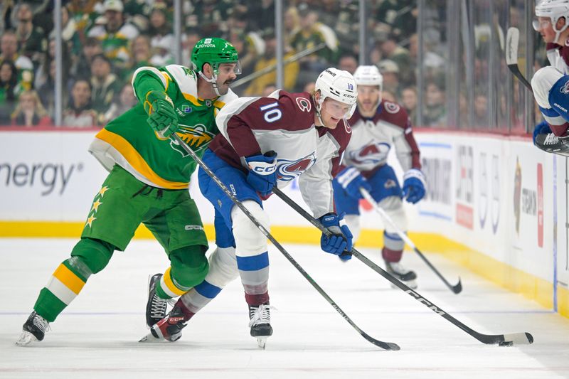 Nov 24, 2023; Saint Paul, Minnesota, USA; Colorado Avalanche forward Riley Tufte (10) protects the puck from Minnesota Wild defenseman Jacob Middleton (5) during the first period at Xcel Energy Center. Mandatory Credit: Nick Wosika-USA TODAY Sports