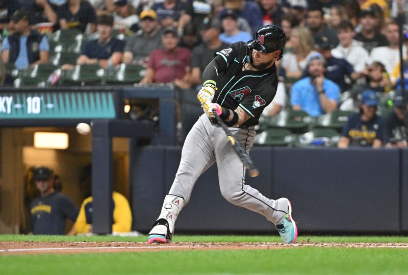 Sep 21, 2024; Milwaukee, Wisconsin, USA; Arizona Diamondbacks catcher Jose Herrera (11) hits a home run against the Milwaukee Brewers in the fifth inning  at American Family Field. Mandatory Credit: Michael McLoone-Imagn Images