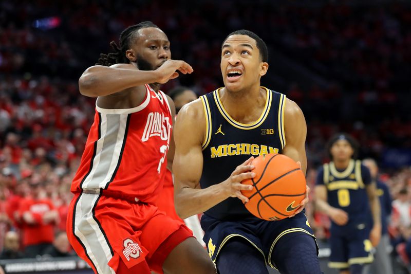 Mar 3, 2024; Columbus, Ohio, USA; Michigan Wolverines guard Nimari Burnett (4) drives to the basket as Ohio State Buckeyes guard Bruce Thornton (2) defends during the first half at Value City Arena. Mandatory Credit: Joseph Maiorana-USA TODAY Sports