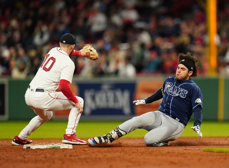 Sep 26, 2023; Boston, Massachusetts, USA; Tampa Bay Rays second baseman Jonathan Aranda (62) slides into second base against Boston Red Sox shortstop Trevor Story (10) on a double in the third inning at Fenway Park. Mandatory Credit: David Butler II-USA TODAY Sports