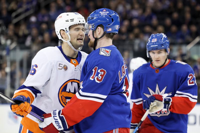 Nov 8, 2022; New York, New York, USA; New York Islanders right wing Oliver Wahlstrom (26) interacts with New York Rangers left wing Alexis Lafreni  re (13) after a check by Wahlstrom during the second period of a game  at Madison Square Garden. Mandatory Credit: Jessica Alcheh-USA TODAY Sports