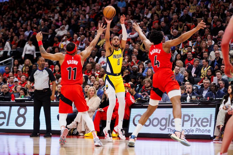 TORONTO, CANADA - FEBRUARY 14: Tyrese Haliburton #0 of the Indiana Pacers puts up a shot between Bruce Brown #11 and Scottie Barnes #4 of the Toronto Raptors during the first half of their NBA game  at Scotiabank Arena on February 14, 2024 in Toronto, Canada.NOTE TO USER: User expressly acknowledges and agrees that, by downloading and or using this photograph, User is consenting to the terms and conditions of the Getty Images License Agreement. (Photo by Cole Burston/Getty Images)