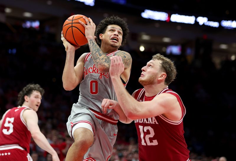 Mar 7, 2026; Columbus, Ohio, USA; Ohio State Buckeyes guard John Mobley Jr. (0) drives to the basket asIndiana Hoosiers forward Tucker Devries (12) defends during the second half at Value City Arena. Mandatory Credit: Joseph Maiorana-Imagn Images