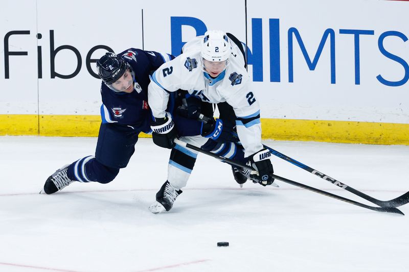 Nov 5, 2024; Winnipeg, Manitoba, CAN;  Winnipeg Jets defenseman Dylan DeMelo (2) and Utah Hockey Club defenseman Olli Maatta (2) battle for the puck during the third period at Canada Life Centre. Mandatory Credit: Terrence Lee-Imagn Images