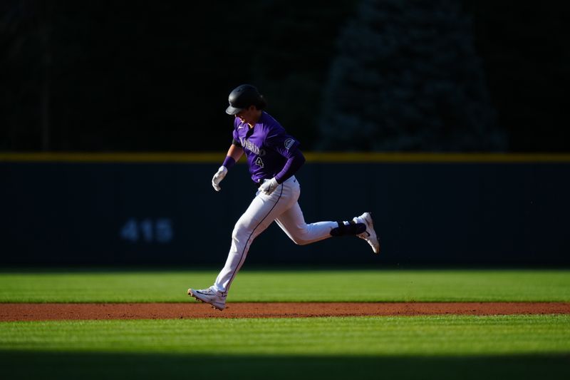 Jun 19, 2024; Denver, Colorado, USA; Colorado Rockies first base Michael Toglia (4) runs off a three-run home run in the first inning against the Colorado Rockies at Coors Field. Mandatory Credit: Ron Chenoy-USA TODAY Sports