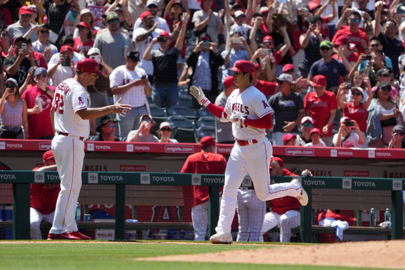 Jul 2, 2023; Anaheim, California, USA; Los Angeles Angels designated hitter Shohei Ohtani (17) is congratulated by third base coach Bill Haselman (82) after hitting a solo home run in the eighth inning against the Arizona Diamondbacks at Angel Stadium. Mandatory Credit: Kirby Lee-USA TODAY Sports